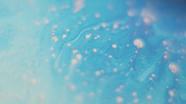 Abstract swirling blue and purple soap bubble macro motion footage with iridescent patterns