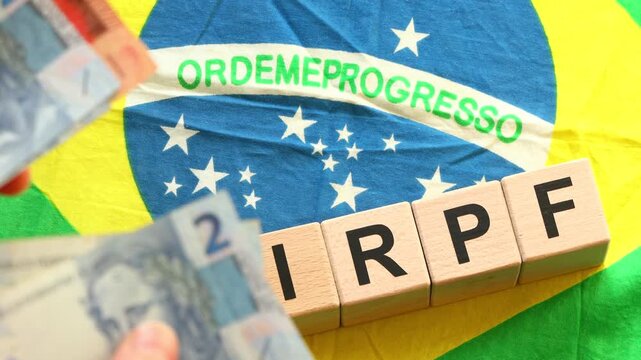 IRPF, Imposto de Renda de Pessoa F&iacute;sica, English translation Personal Income Tax. Financial concept. Taxes in Brazil. written on wooden blocks, Brazilian flag, business background