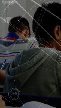 Vertical video: Teen in hoodie writing then turning sharing classroom glance while HUD animating