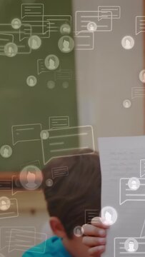 Vertical video: Student rising, presenting paper in education class, chat icons floating over her
