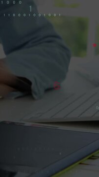 Vertical video: Coder hand tapping stylus on tablet causing C++ code overlays while checking paper