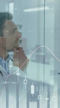 Vertical video: Doctor glancing at glass scanning charts crossing torso touching chin deciding care