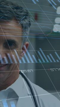 Male doctor after reading blue tablet lifting head locking eyes while charts animating over steth