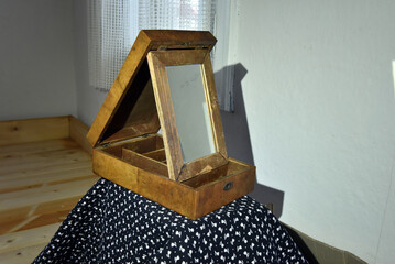 Antique wooden vanity box with an adjustable mirror