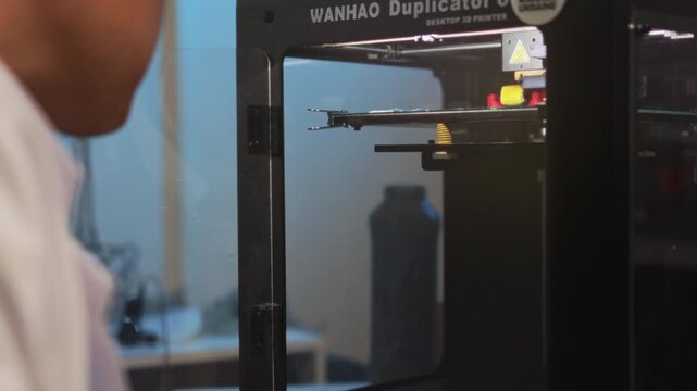 Technician tunes printing device, Skilled technician ensures printer operates with correct calibration levels
