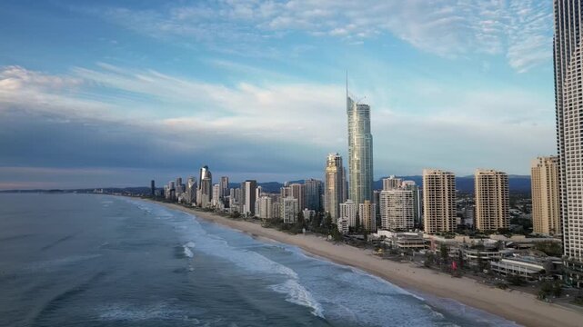 Aerial view of surfers paradise beach at sunrise on gold coast with city skyline against beautiful sky