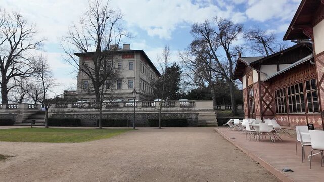 Prague, Czech Republic - March 11, 2026 - Gr&ouml;be Villa in Havlicek Gardens. Elegant building with people and car in winter