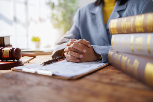 Lawyers Consultation and conference discussing legal matters at a desk with a gavel, scales of justice law symbolizing law and justice, justice and lawyer Business partnership meeting concept.