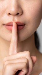 Fototapeta premium Silent gesture of a woman studio setting portrait photography minimalist environment close-up viewpoint concept of secrecy