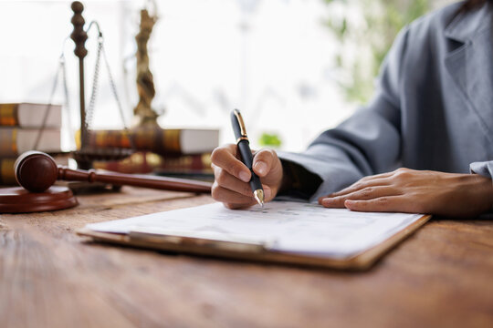Lawyers discussing contract papers sitting in the table at office in the morning.Legal law, lawyer, advice and justice concept.

