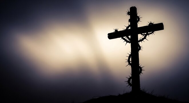 Silhouette of a Wooden Cross Adorned with a Crown of Thorns Against a Dramatic Sky.