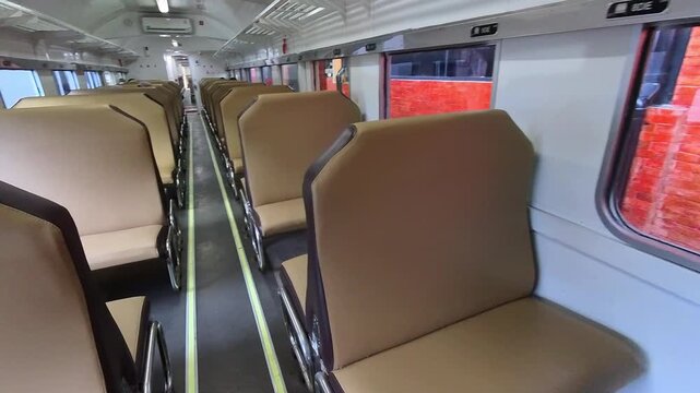 First-person video inside an empty train carriage with no passengers and stopped at a station. Footage traveling along a local Indonesian train in Steady 4k High Resolution