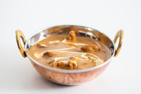 Traditional Indian vag and chicken curry served with naan flat bread. Indian curry, chicken tikka masala with rice and naan bread. Dark background. Copy space.