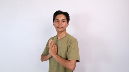 Obraz premium Asian young man smiling greeting gesture