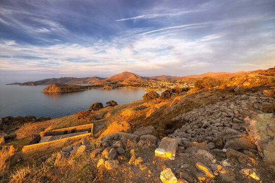 Lemnos Myrina town and its tranquil bay viewed from the ancient castle ruins, illuminated by the warm light of a sunset