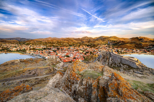 Lemnos Myrina town viewed from ancient castle, showcasing traditional greek village architecture and calm bay, set against rolling hills