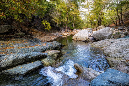 Samothraki Fonia Gorge. Clear river water winding through rocky terrain and green forest in rema tou fonia.
