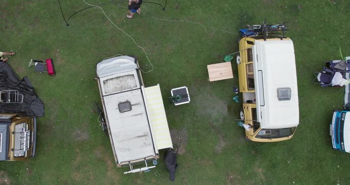 Top-down view of campers and vans in an outdoor camping site gathering with oldtimer vehicles