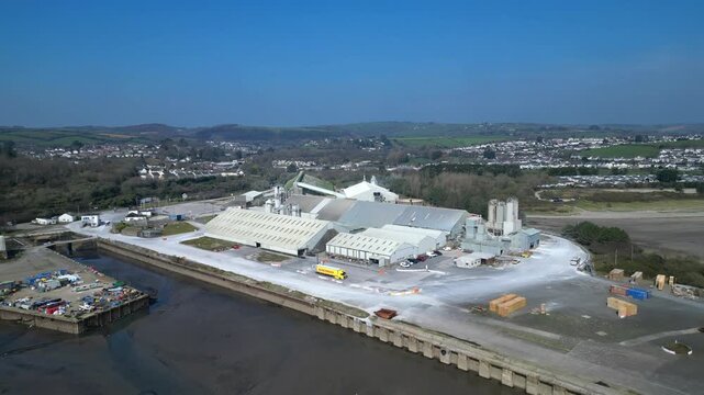 Par, Cornwall, England: DRONE VIEWS: Par Docks with the town of Par and Par Sands beach in the b/g. The Docks is a milling centre and also receives a slurry form of china clay for transporting.