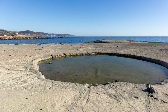 White trachyte rocks and turquoise sea at Cane Malu beach, Bosa, Sardinia, Italy.