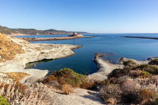 White trachyte rocks and turquoise sea at Cane Malu beach, Bosa, Sardinia, Italy.