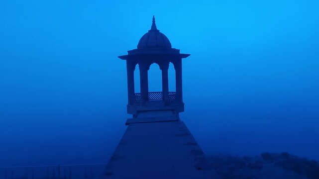 Scenic view of Brahmand Ghat on Yamuna river in Mathura, Uttar Pradesh during foggy morning. Historic riverside monument with peaceful spiritual atmosphere, showcasing Indian culture, heritage.