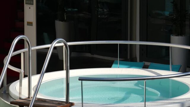 Jacuzzi pool under sunlight divided into four sections reflecting white bridge calm luxury outdoor spa serene water surface