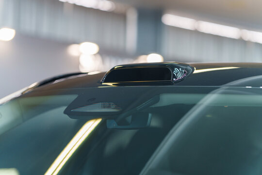 Autonomous driving technology with LiDAR sensor on car roof and ADAS cameras behind windshield