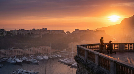 Obraz premium A man kneels to propose to a woman on a terrace overlooking a marina filled with yachts during a vibrant sunset.