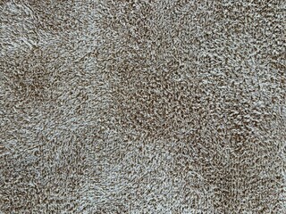 Full frame background texture of soft beige fluffy bath towel cloth material © cholidridwanul