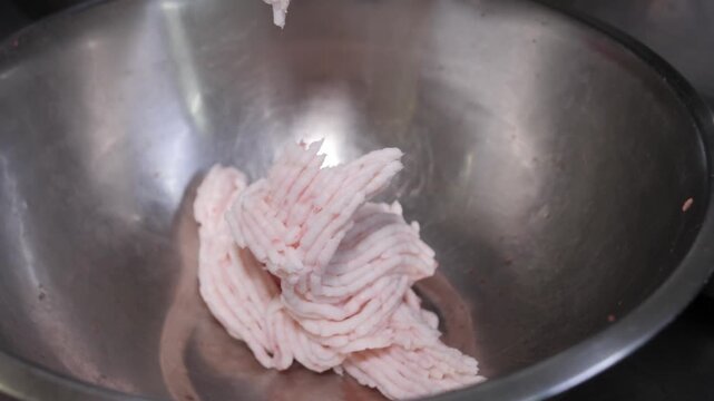 Industrial meat grinder processing fresh raw pork fat