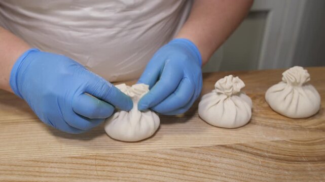 Professional chef making traditional georgian khinkali dumplings