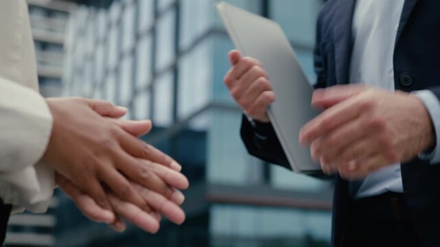 Close up handshake business deal in city multiracial man woman agreement outdoor African American businesswoman Caucasian businessman partnership trust negotiation corporate diversity teamwork gesture