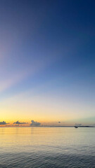 Fototapeta premium 夕暮れの沖縄の海、南国、黄昏時の穏やかな海景色 名嘉真の浜