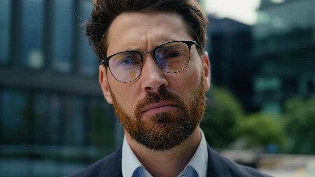 Sad exhausted Caucasian business man in city outdoors looking at camera wearing glasses stressed male manager portrait entrepreneur guy boss leader problem fatigue worry professional businessman work