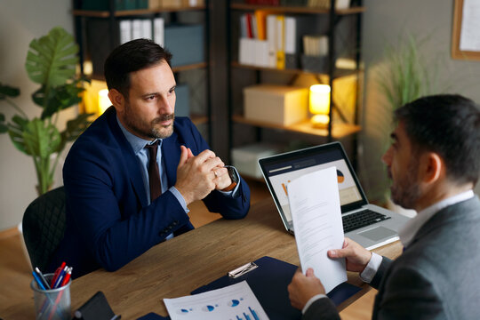 Business professionals discussing agreement during corporate meeting