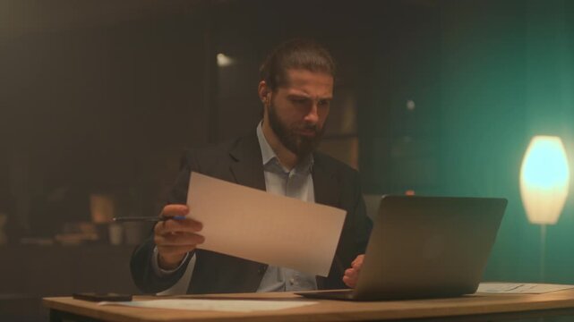 Night entrepreneur preparations, Entrepreneur meticulously analyzing financial data with laptop and papers overnight