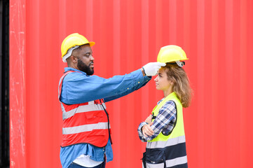 Safety first — Senior worker guiding a young trainee at container yard with protective equipment. Teamwork and safety training in logistics industry.