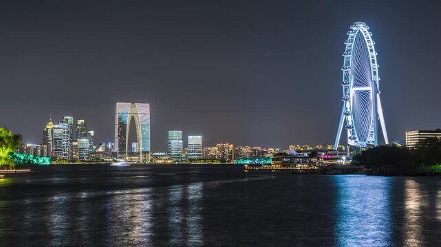 Night time-lapse of Gate of the Orient and Suzhou Eye Ferris wheel at Jinji Lake, Suzhou, Jiangsu, China