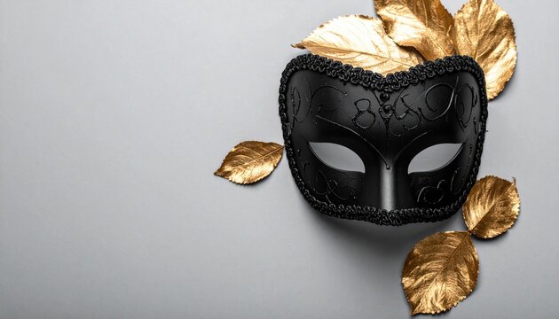 Black Venetian Mask with Golden Leaves on Gray Background.