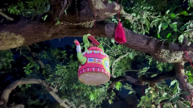 Hand-Painted Traditional Tea Kettle Hanging from a Tree for Boishakhi Festival