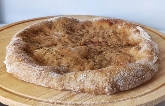 Whole wheat focaccia bread on wooden board