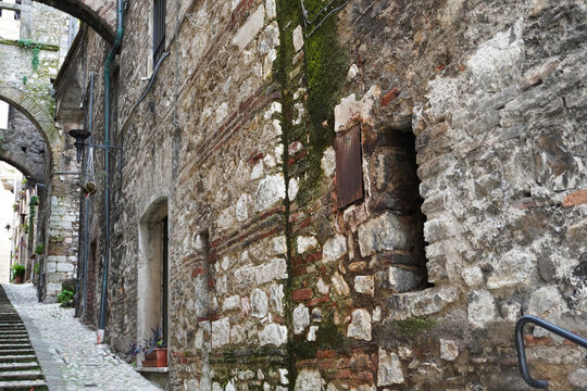 Picturesque alley with stairs in the medieval town of Narni. Umbria region, central Italy. Medieval city: a typical old street. Holidays in Italy. Ancient italian city rich in history. A cobblestone s