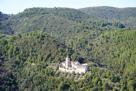 The Benedictine Abbey of San Cassiano near Narni, Umbria, Terni, Italy. The green hills covered by the forest. Distance view. View from the medieval town of Narni. Umbria region, central Italy.