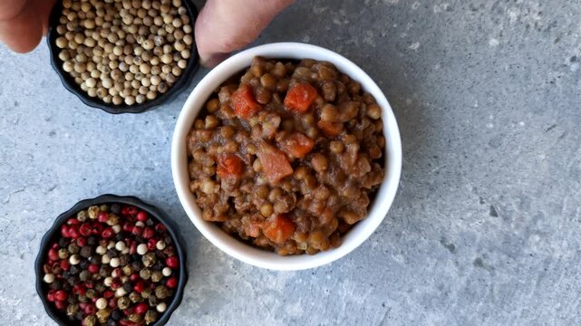 Lentil, carrot, and tomato stew with sausages, a European dish. Lentils with sausages as a food background for your design