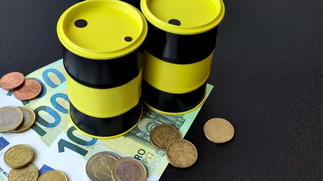 A barrel of oil against a backdrop of euro as a concept for the global oil crisis and rising prices. A barrel of oil and euro as a background for your design
