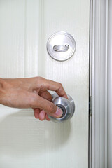 Naklejka premium Ensuring safety by engaging both the doorknob lock and deadbolt for extra protection