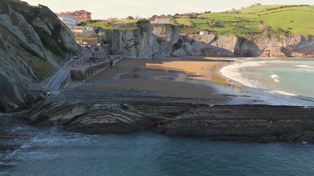 Aerial view of Itzurun Beach cove with flysch rocks and coastal cliffs