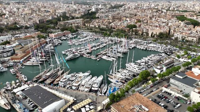 Detailed aerial view of Palma Cathedral and the fortified old town of Palma de Mallorca on Mallorca, Spain. The video highlights Gothic architecture, historic walls, waterfront promenade, and dense ur