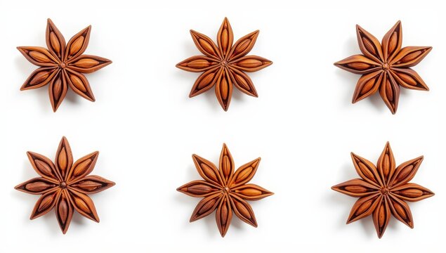 Six anise stars on a white backdrop.